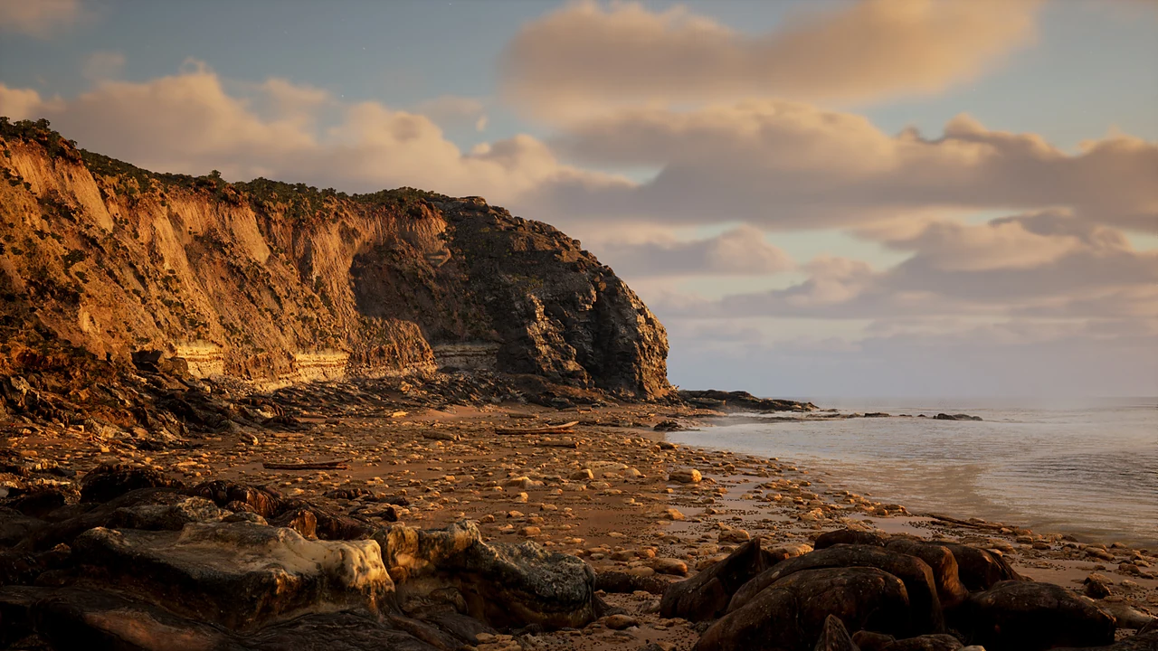 Golden sea cliffs above a rocky beach at sunset